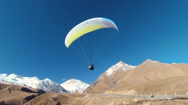 Paragliding - Caucasus Mountains, Friendship Monument, Caucasia, Gudauri, Georgia, Europe / Asia.