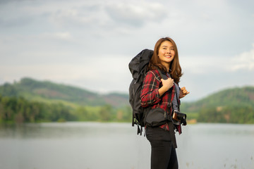 happy smiling wanderlust Asian women tourist hipster backpack to travel and rise hand in green wild forest trip hiking outdoor vacation make a journey holiday,nature lifestyle, Traveler hike concept