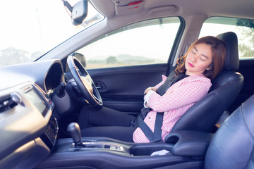 Excessively tired young Asian women driving,sleeping in car