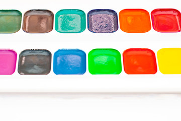 Watercolor in a box close-up. Multi-colored paint palette