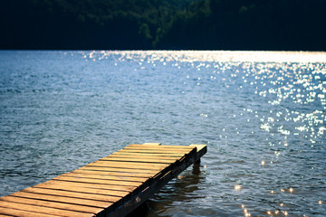 Wooden pier on the lake. Blur background