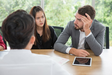 Depressed boss during a meeting in office . businessman stressed  holding hands on head Serious