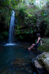 woman next to waterfall
