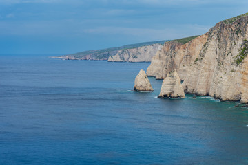 Fototapeta premium Greece, Zakynthos, Two little rocks next to cliffy coast in twilight atmosphere