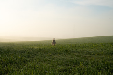 Girl in the morning foggy field