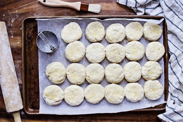 Raw buttermilk southern biscuit or scone dough from scratch with rolling pin and basting brush. Top...