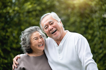 Senior Couple laughing at the park.