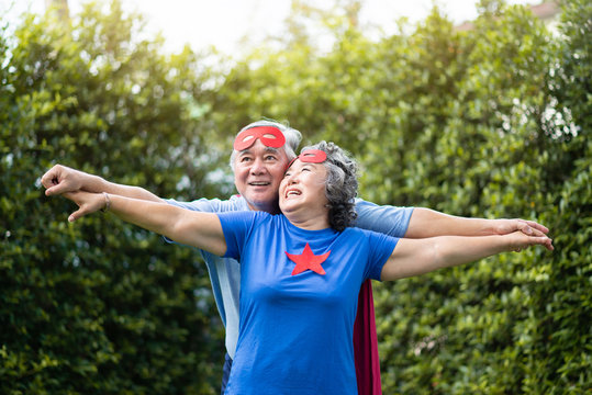Asian Senior couple in Superhero costume relaxing