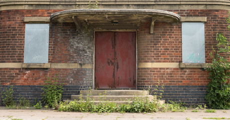Fototapeta na wymiar Derelict Art Deco style building doorway