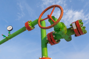 Horizontal view of a wellhead with valve armature. Oil and gas industry concept.  Oil valve with...