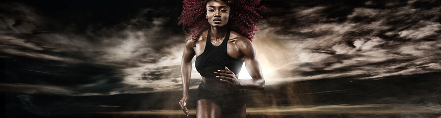 Strong athletic woman sprinter, running on dark background wearing in sportswear. Fitness and sport...