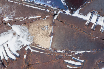 Part of the construction of an art object made of aged metal.