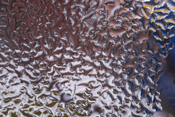 Water drops on glass window close up with blurred background. Drops in macro. Condensate on window...