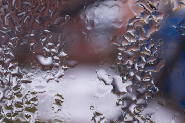 Water drops on glass window close up with blurred background. Drops in macro. Condensate on window...