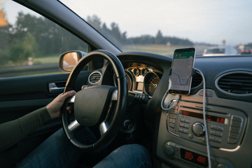 view from a car traveling a road in time for the sunset