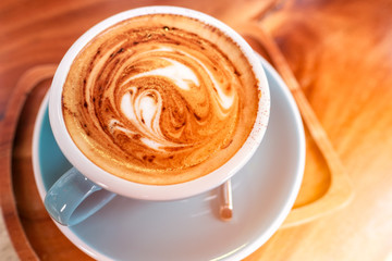 Late art coffee with heart shape on wood table background. Top view.