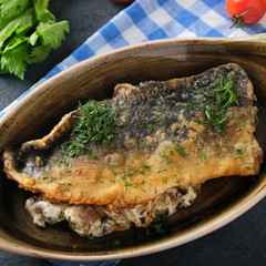 Fried carp fillet on a plate. Closeup