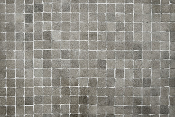 Old grey mosaic wall background texture