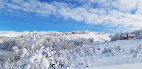 Fototapeta na wymiar Mysterious winter landscape majestic mountains in winter. Magical winter snow covered tree. Winter road in the mountains. In anticipation of the holiday. Dramatic wintry scene.