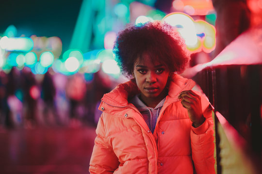 Black woman standing on night city street