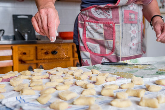 Above View Of Young Italian Housewife Woman Hands Making Fresh Traditional  Homemade Italian Gnocchi Pasta On Table With Flour