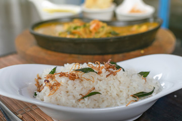 Close up of rice with shrimps curry in a pan on the background