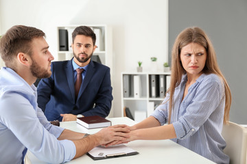 Obraz premium Young emotional couple visiting divorce lawyer in office