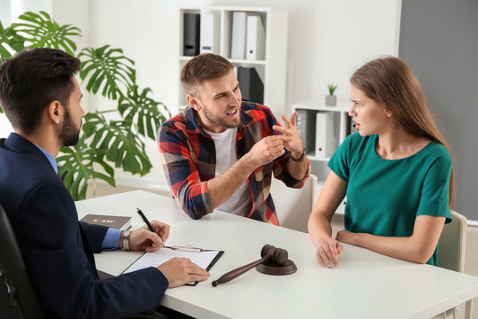 Young Emotional Couple Visiting Divorce Lawyer In Office