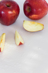 Top view of crispy red apples on white background, space for text.  Healthy eating, agricultural industry concept