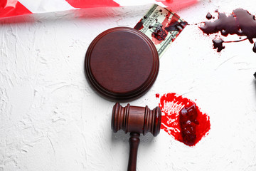 Composition with gavel, blood and money on white background. Concept of corrupt judge