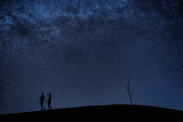 Fototapeta premium Silhouette of young couple under stars. The concept on the theme of love