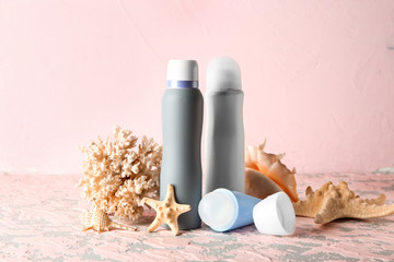 Deodorants, starfish and coral on table