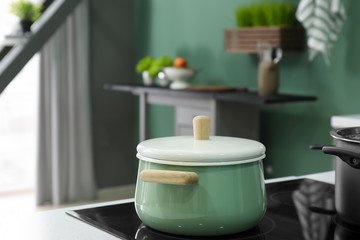 Pot on modern electric stove in kitchen