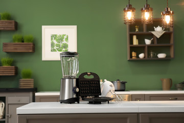 Modern appliances on light table in kitchen