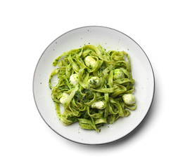 Plate with tasty pesto pasta on white background