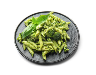 Plate with tasty pesto pasta on white background