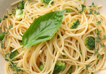 Tasty pasta with basil and broccoli, closeup