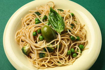 Plate with tasty pasta on color background, closeup
