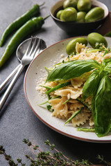 Plate with tasty pasta on grey table