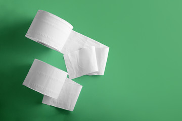 Rolls of toilet paper on color background
