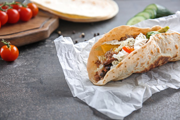 Tasty taco on grey table