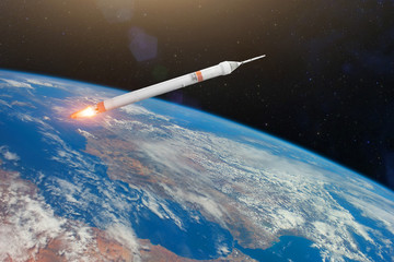 Space rocket with fire burn engines orbiting Earth planet. Elements of this image furnished by NASA.