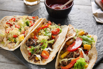 Tasty tacos on table