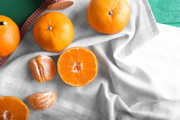 Tasty juicy tangerines on light napkin