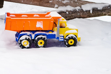 snow covered toy truck in the snow