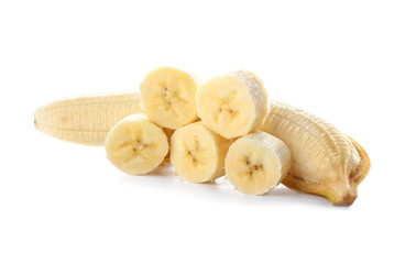 Tasty fresh banana with pieces on white background
