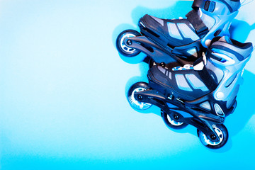  roller skates on a blue background headphones sports equipment rollers wheels active leisure style...