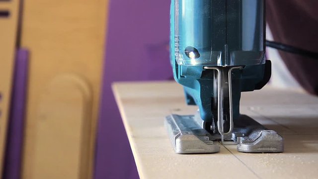 Plywood cutting. Working with  electric fret saw