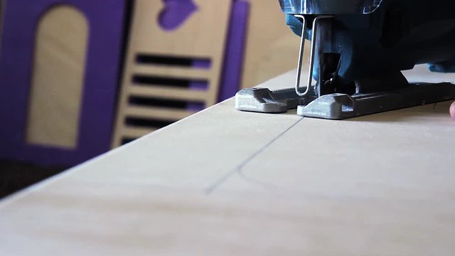 Plywood cutting. Working with  electric fret saw
