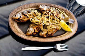 Fried fish and onion with lemon